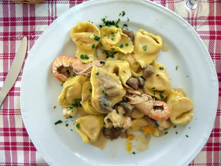 Pumpkin Cappellacci with scampi and porcini mushrooms